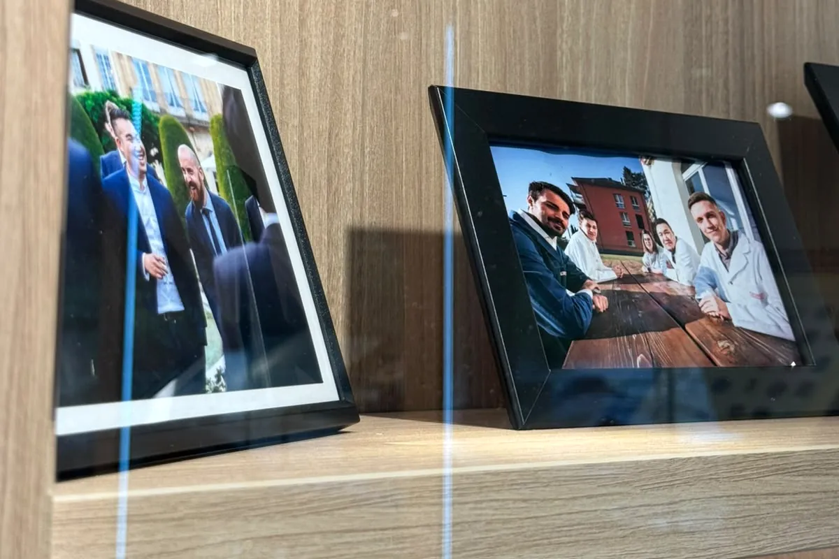 Framed photographs on a shelf in the showroom